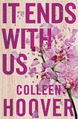 Book cover of 'It Ends with Us' by Colleen Hoover with pink flowers on a wooden background